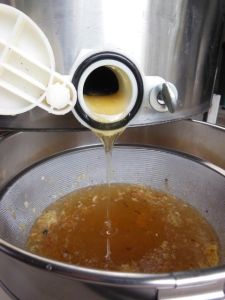 Screening the newly harvested honey. 